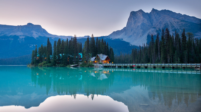 Reflections on the water at sunrise over a cabin on Emerald Lake in British Columbia