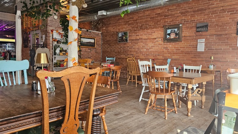 Cozy interior of Georgie's Cafe in Nanton, Alberta, with brick walls and wooden furniture