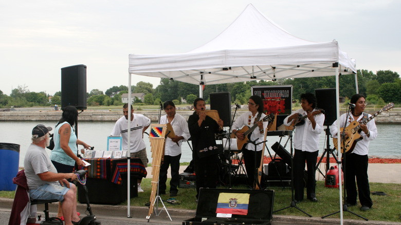 Musicians perform under a pop-up tent beside the canal on the promenade in Port Colborne during the Canal Days Festival.