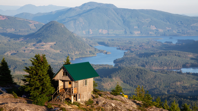 Tin Hat Hut surrounded by mountains, forest, and lakes on the Sunshine Coast Trail