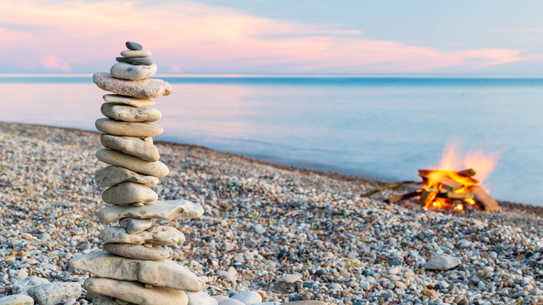 Rocks stacked on the beach next to a campfire on Lake Huron in Bayfield, Ontario, Canada