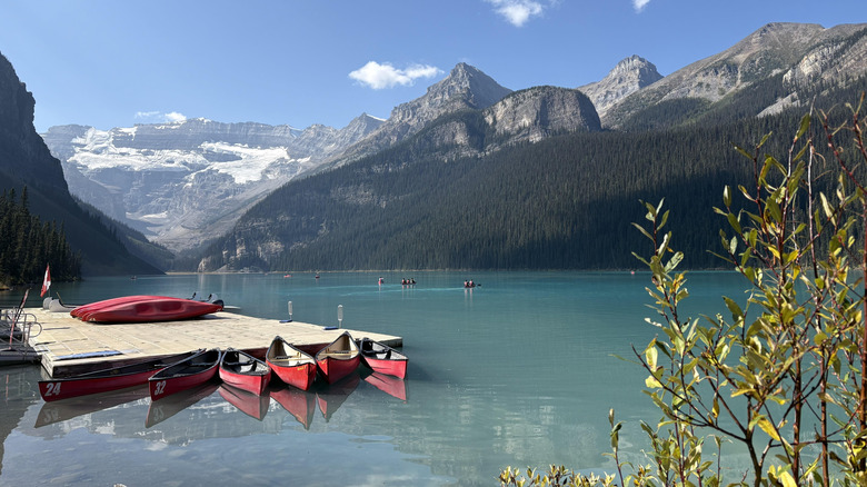 Canoes on Lake Louise surrounded by mountains
