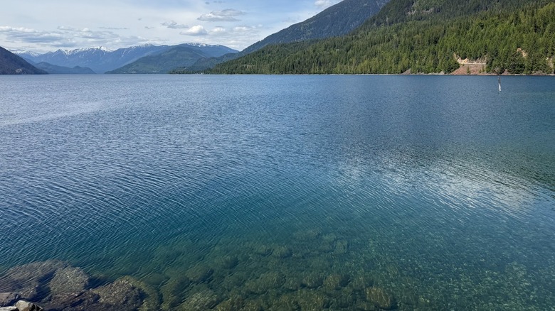 View of snow-capped peaks and forested hills at Slocan Lake in Silverton, B.C.