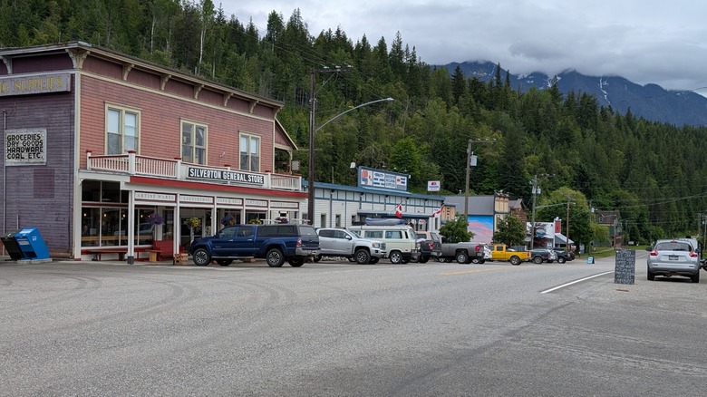 View of buildings, forest, and mountains along Highway 6 in Silverton, British Columbia