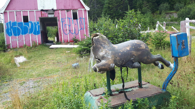 Decrepit coin ride and barn at the Trinity Train Loop in Newfoundland