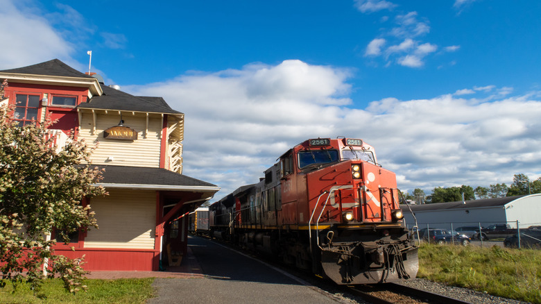 A train arriving at a train station in Amqui, Canada