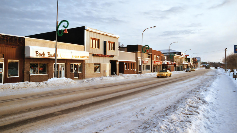 Cars driving past restaurants and shops in Sioux Lookout after heavy snowfall