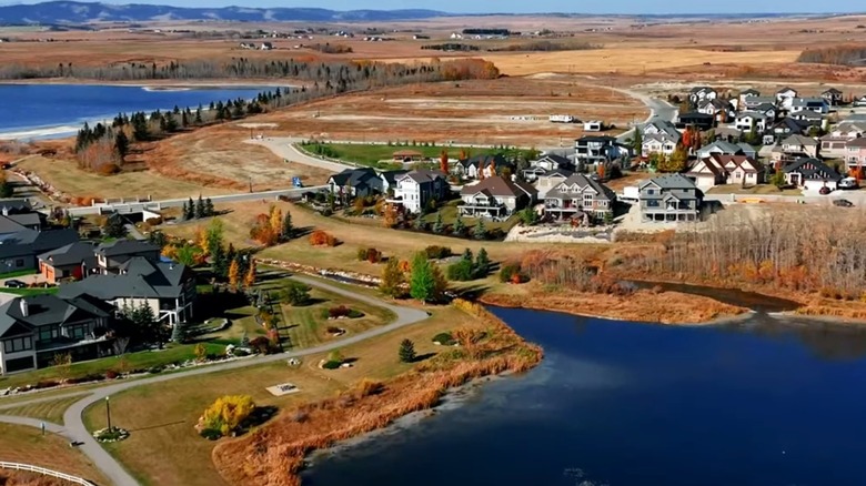 An aerial view of houses and lakes in Cochrane, Alberta