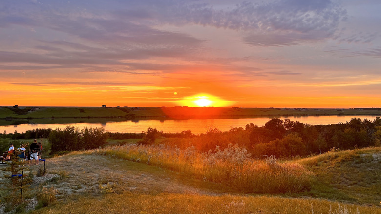 Sunset over the hills and grassland near Blackstrap Lake at Sunset Ridge Campground