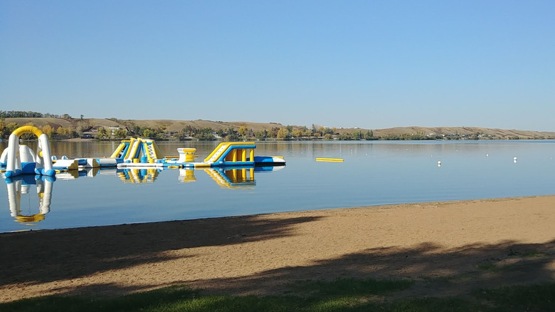 Inflatable water slides near the sandy beach at Blackstrap Provincial Park, Saskatchewan