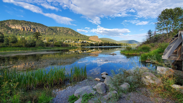 Pretty scenery of lake, grassy shoreline, and hills at Scout Island Nature Center, Williams Lake