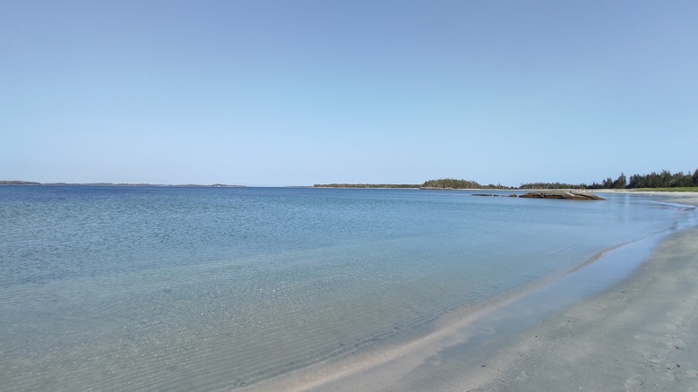 Crystal-clear waters and smooth sands with islands in the background