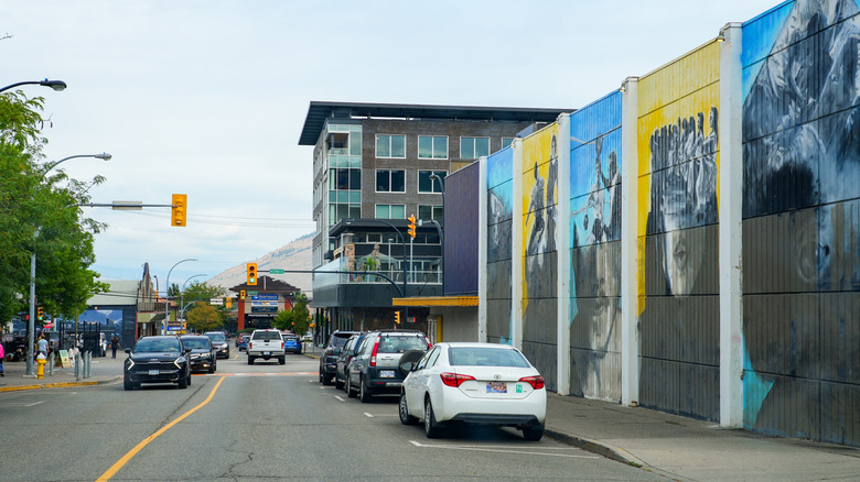 Several large colorful mural panels on a city street in Kamloops