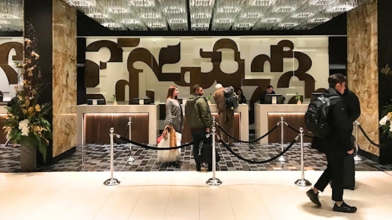 Hotel guests in the lobby of Fairmont The Queen Elizabeth in Montreal, Canada