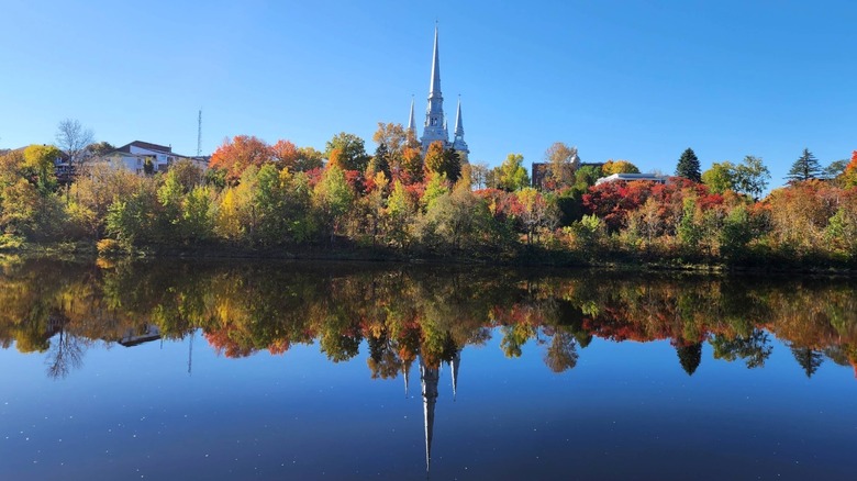 Saint-Georges Church reflected in a river in Québec