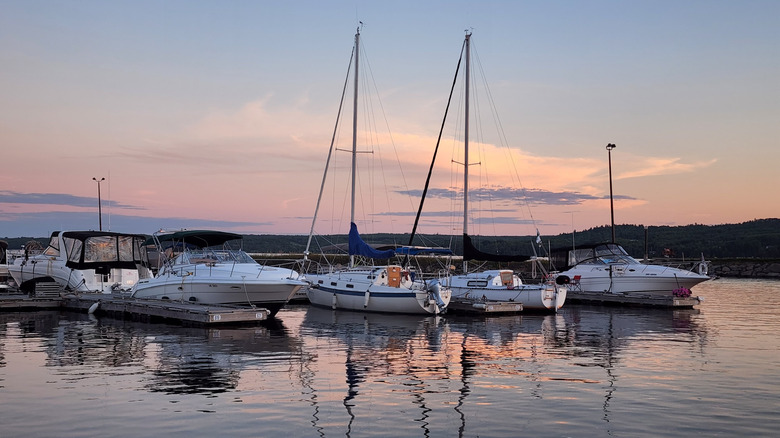 A view of boats in the water at Lake Temiskaming, roped at the pier.