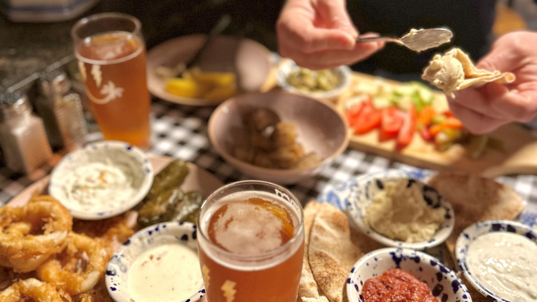 A table full of food and beer at a restaurant in Bloomfield, Ontario
