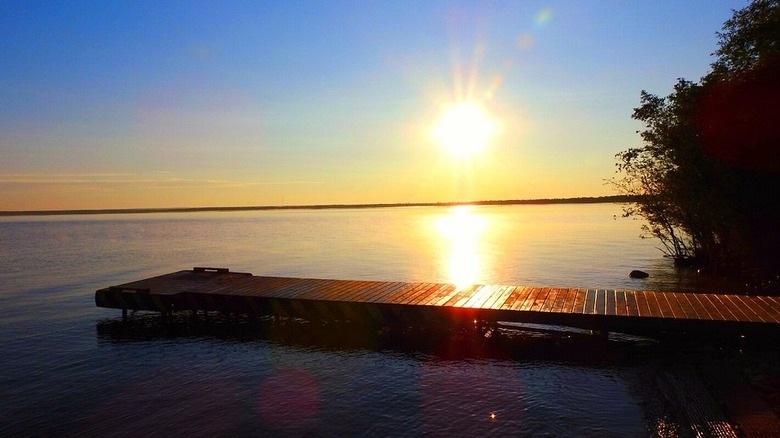 View of Calling Lake at sunset with a dock