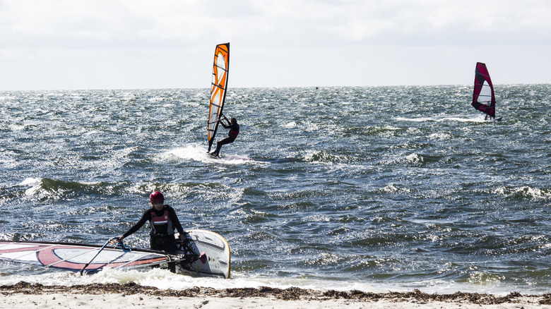 Three people windsurfing at Kalmus Beach
