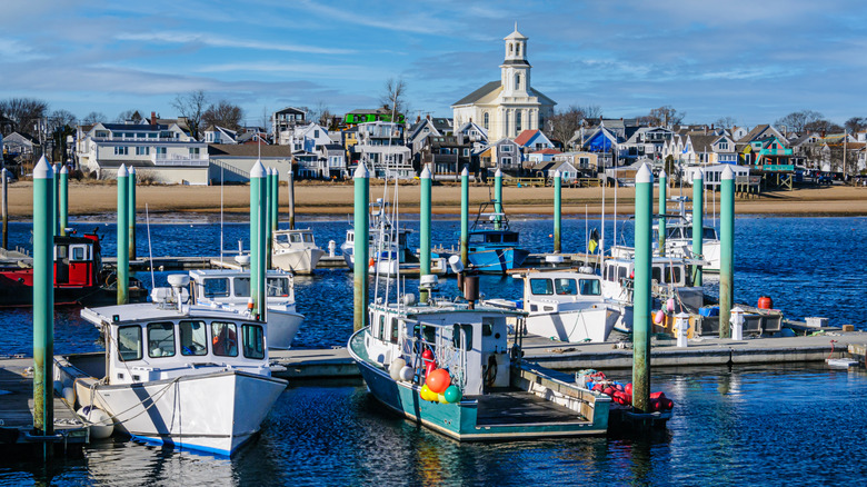 Fishing boats are docked at a marina on a sunny day in Provincetown, Massachussetts