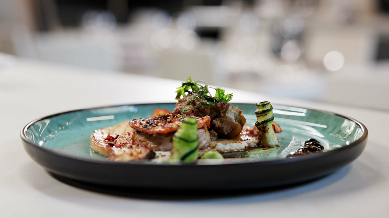 Closeup of a plated dish of fish and vegetables