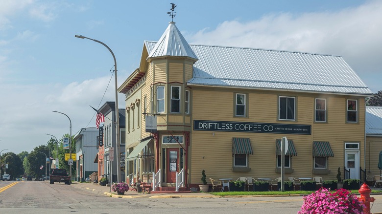 The historic downtown streets of Cassville with the yellow  Driftless Coffee Co on a corner and historic building running along the street next to it