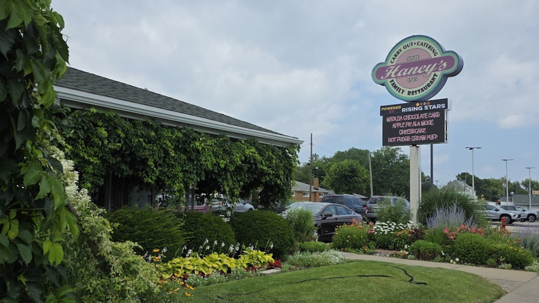Haney's Family Restaurant in Center Line, Michigan, with lush green gardens and a blue sky