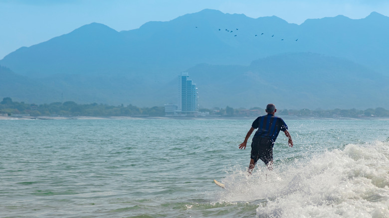 A man surfing at the beach in Coronado, Panama