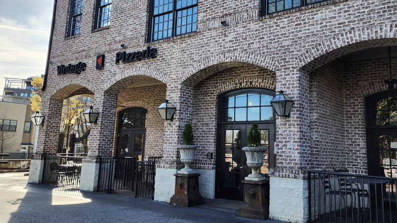 The brick exterior of Vintage Pizzeria on a bright day in Chamblee Georgia