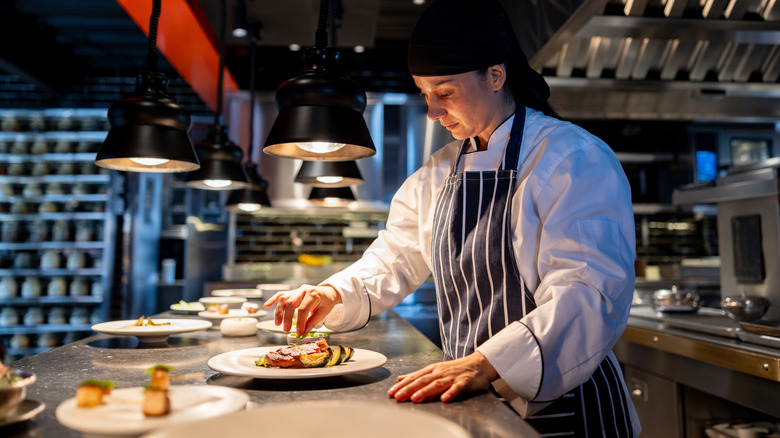 Chef plating dish on counter