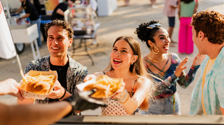 People receiving food from a food truck vendor