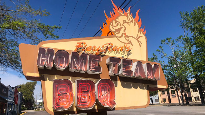 Home Team BBQ's light up front sign with a flaming pig