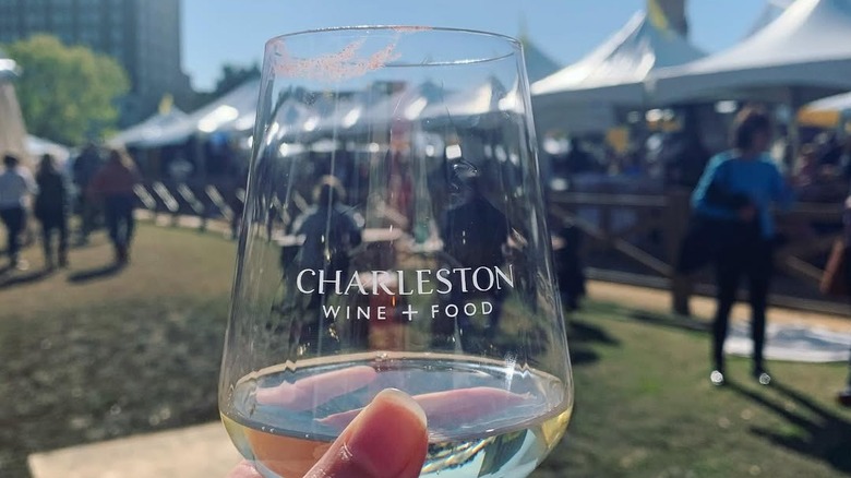 A woman holds a wine glass at Charleston Wine + Food festival