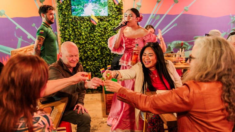 Four people enjoy drinks together at the Charleston Wine + Food Festival