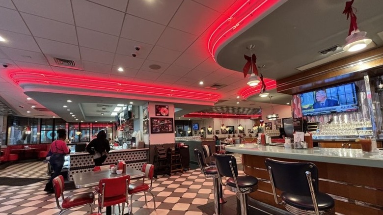 Red neon lights 1950s interior RedEye diner counter tables and stools