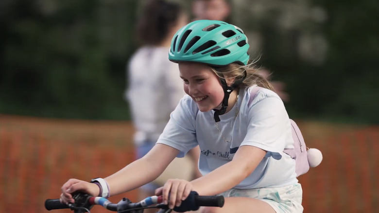 A young girl rides her bicycle during the 24 Hours of Booty charity cycling event on the Booty Loop.
