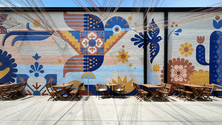 Mural and outdoor seating at Maiz Agua Sal