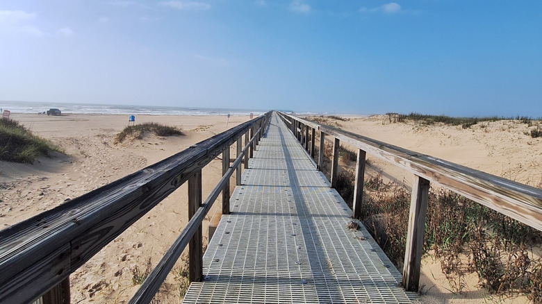 Boardwalk on the sandy shore of Matagorda Bay Nature Park, Texas.