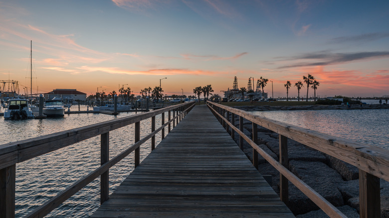 Sunset over the beach and pier of Port Aransas, Texas.