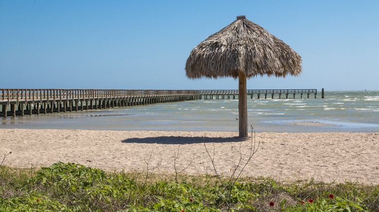 Pier and palapa at the beach of Rockport, Texas.