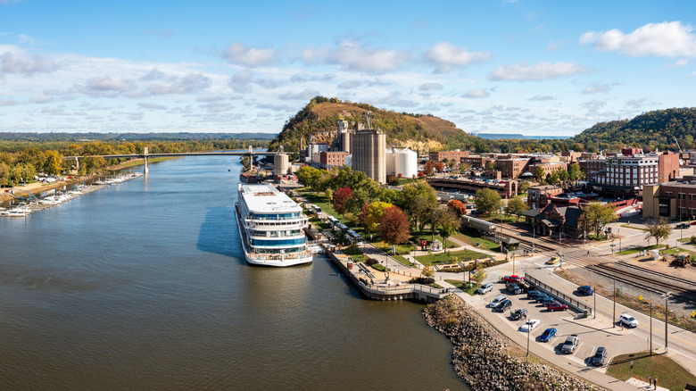 Red Wing, Minnesota with a large boat in the water with surrounding hills on the Mississippi River