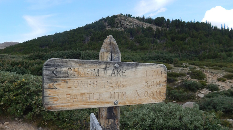 A wooden sign points hikers towards Chasm Lake.