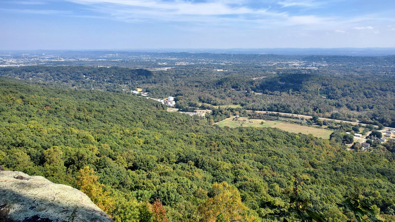 An overlook showing view for miles including buildings and trees