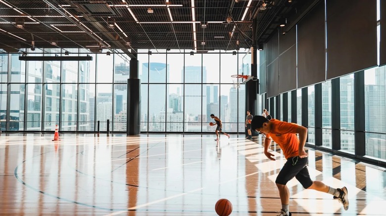 People dribbling basketballs and playing inside Swish House in Chicago.