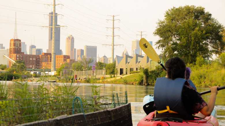 A kayaker paddles around Wild Mile with the Chicago skyline in the background
