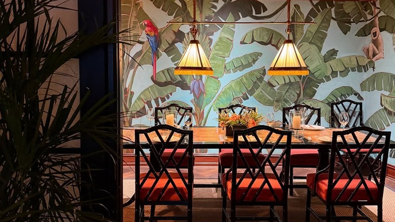 The private dining room at Le Colonial in Chicago adorned with vibrant wallpaper and unique light fixtures