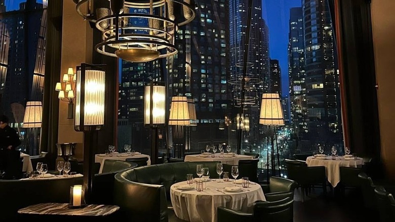The dining room at Tre Dita in Chicago with skyscraper views out the window