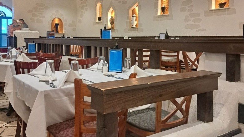 The interior of Chicago's Greek Islands restaurant with faux stone walls and wood furniture
