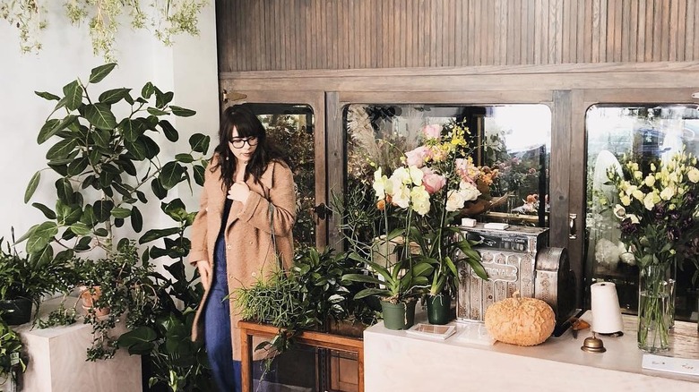 A woman standing by the counter in Cornell Florist