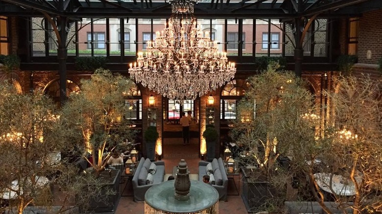 chandelier above fountain surrounded by trees